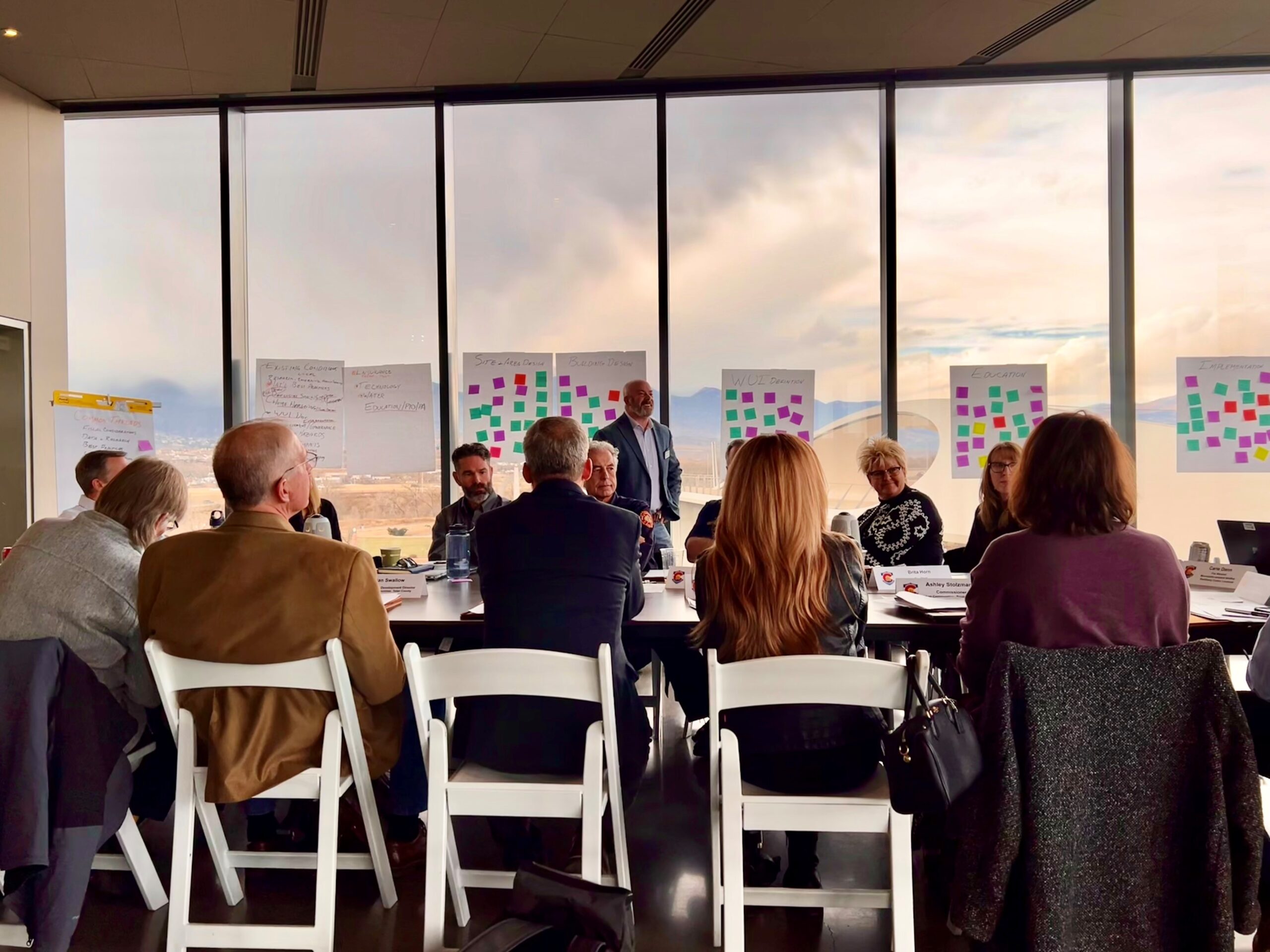 photo of a facilitator and a large group meeting