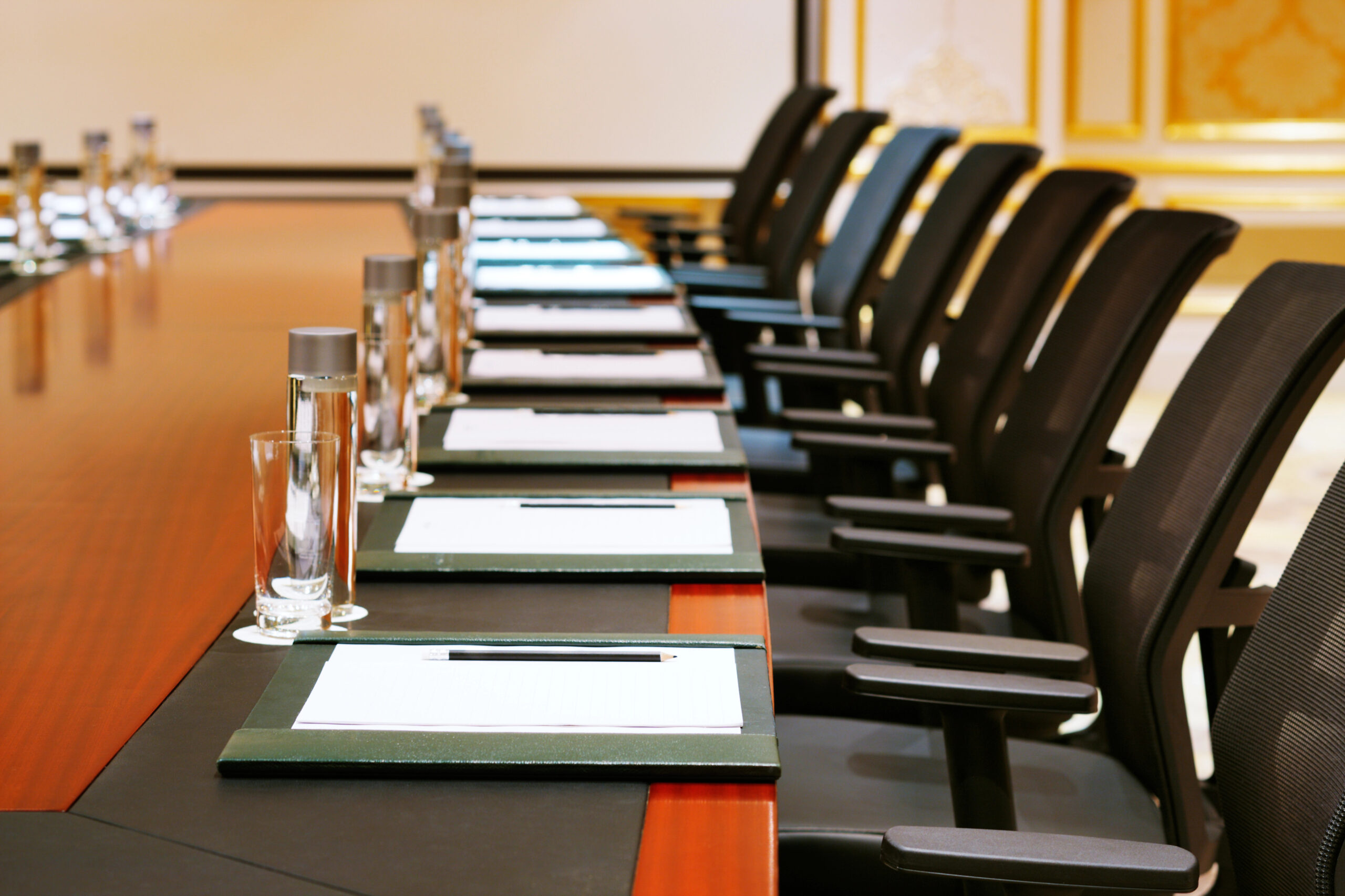 Picture of a conference table with empty chairs