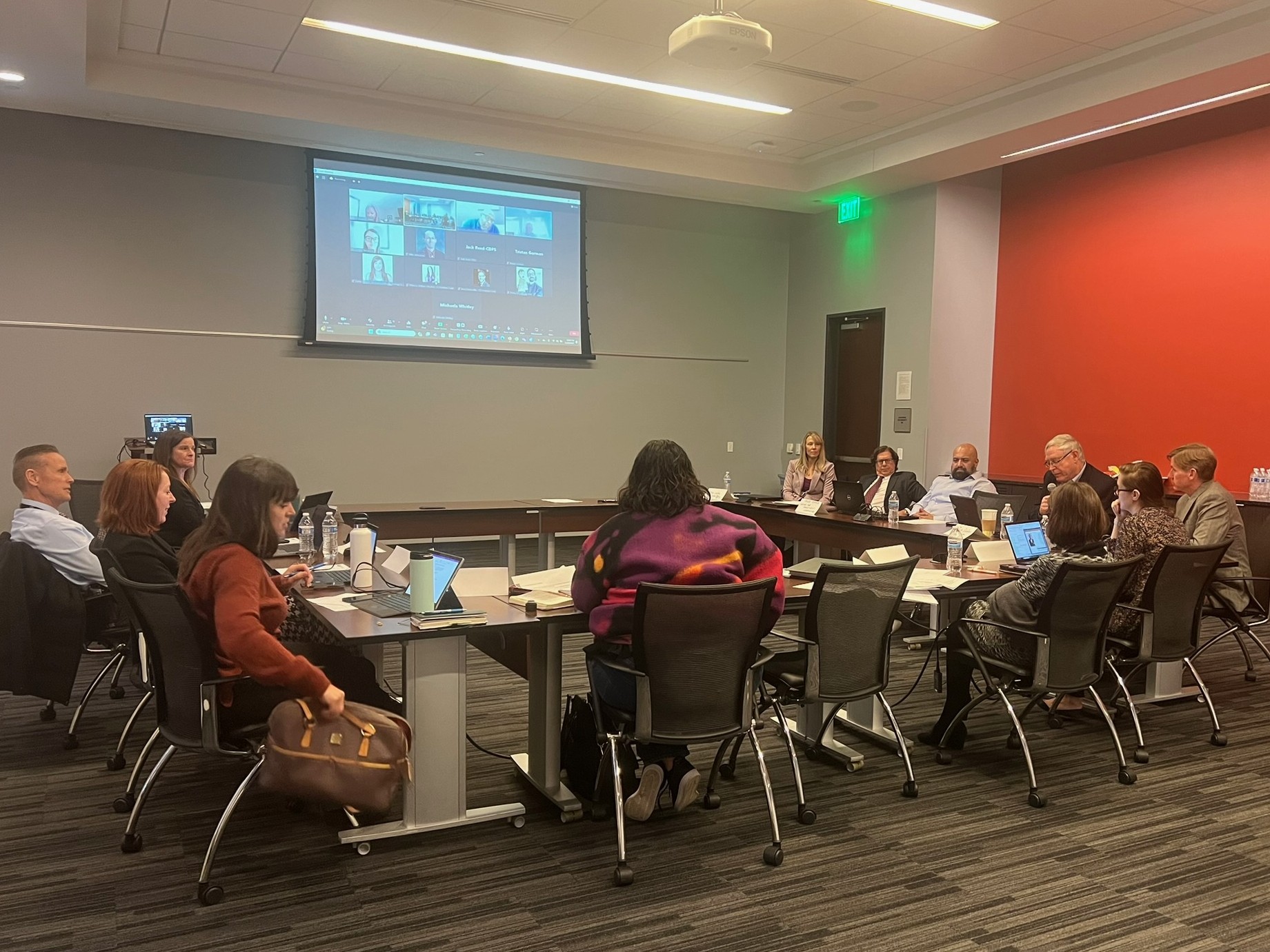 Group of people seated at large table for meeting